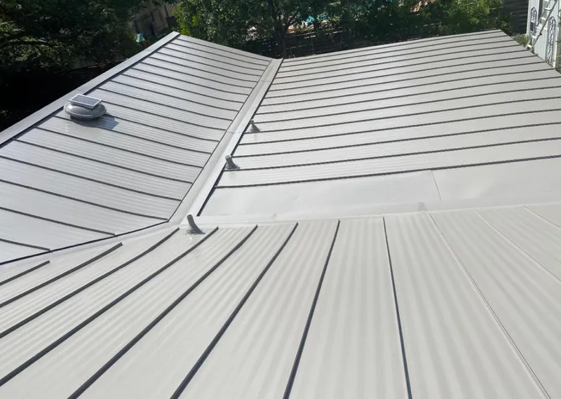 Solar attic fan installed on a metal roof for Roof Ventilation in Santee